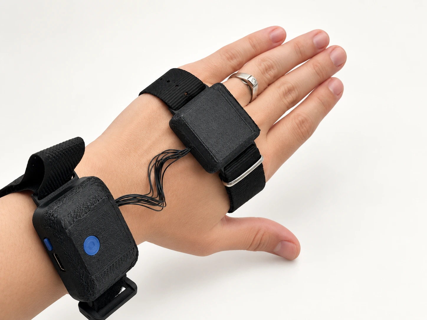 Assembled wearable showing enclosure depth and wrist-and-hand placement